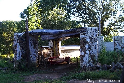 The stone walls of an old barn back wiew