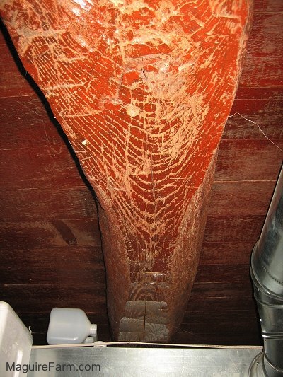 Close up - red colored old basement wooden beam with axe marks in it